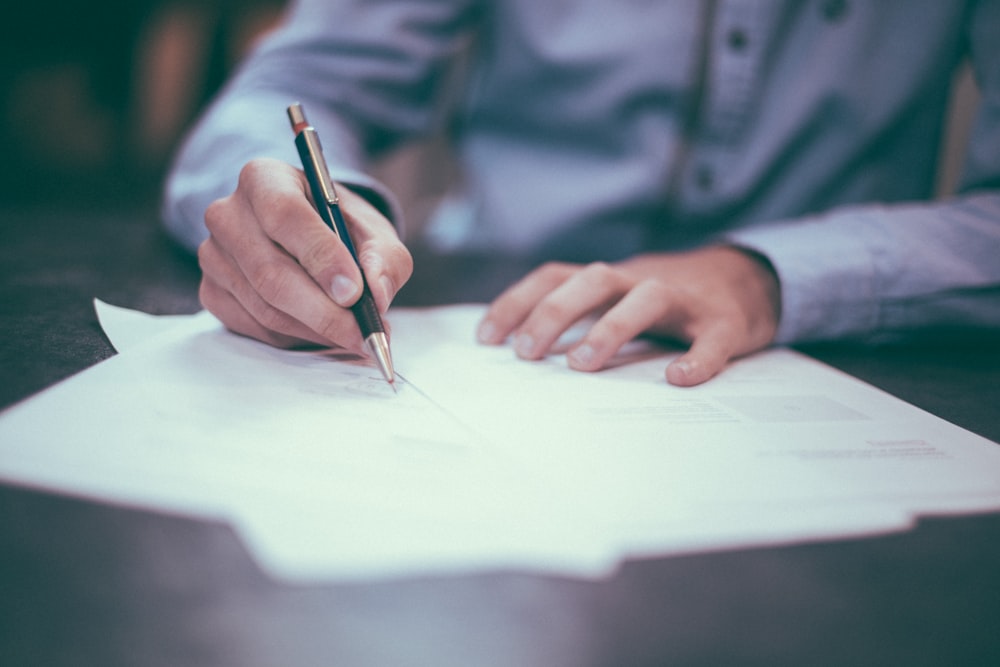Broker reviewing and signing customs paperwork