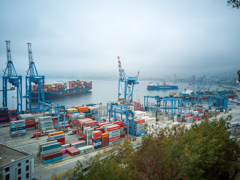 Container ship at a busy port with shipping containers stacked dockside